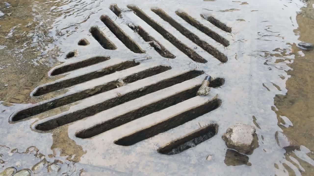 Water flowing into a storm drain on a construction site