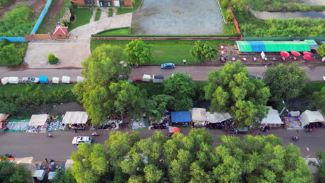 vehículos de crucero a través del mercado callejero de ropa en siem reap camboya