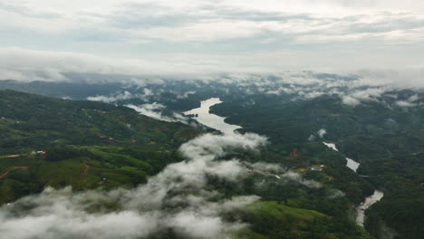 aerial view over low hanging clouds in the highlands of antioquia, colombia