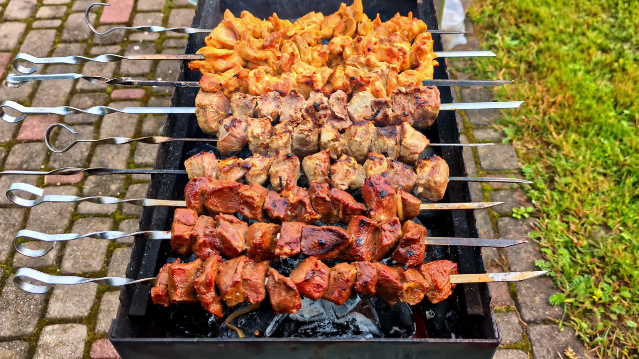 Closeup shot of chicken kebabs on skewers on barbeque
