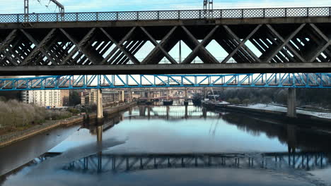 bird flies past beautiful aerial of bridges and reflections on the river tyne, newcastle