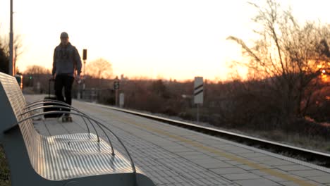 young adult man waiting on railway station