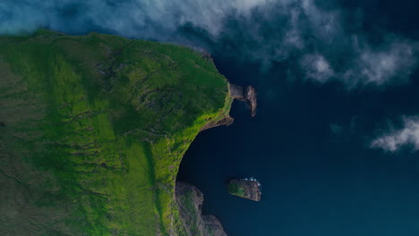 Dramatic Aerial View of a Green Cliff and Sea Stack on the Coast