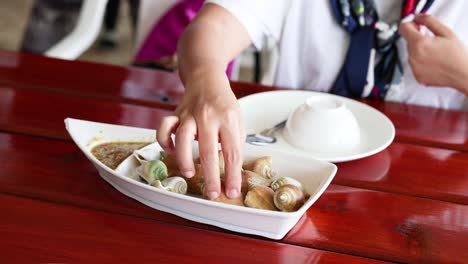 person savoring boiled wing shell seafood