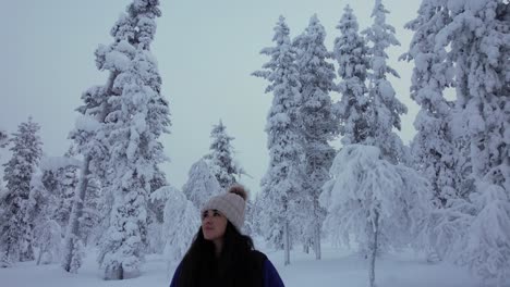 Beautiful-Girl-Exploring-Scenery-In-Snowy-Forest-In-Lapland,-Finland,-Arctic-Circle