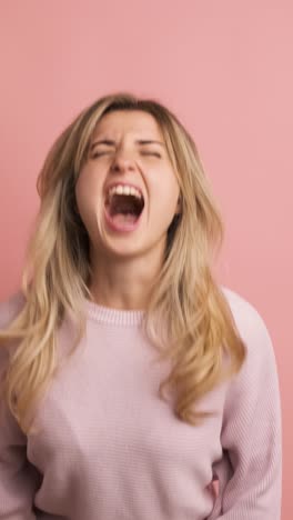 desperate woman yelling with eyes closed and hands on head