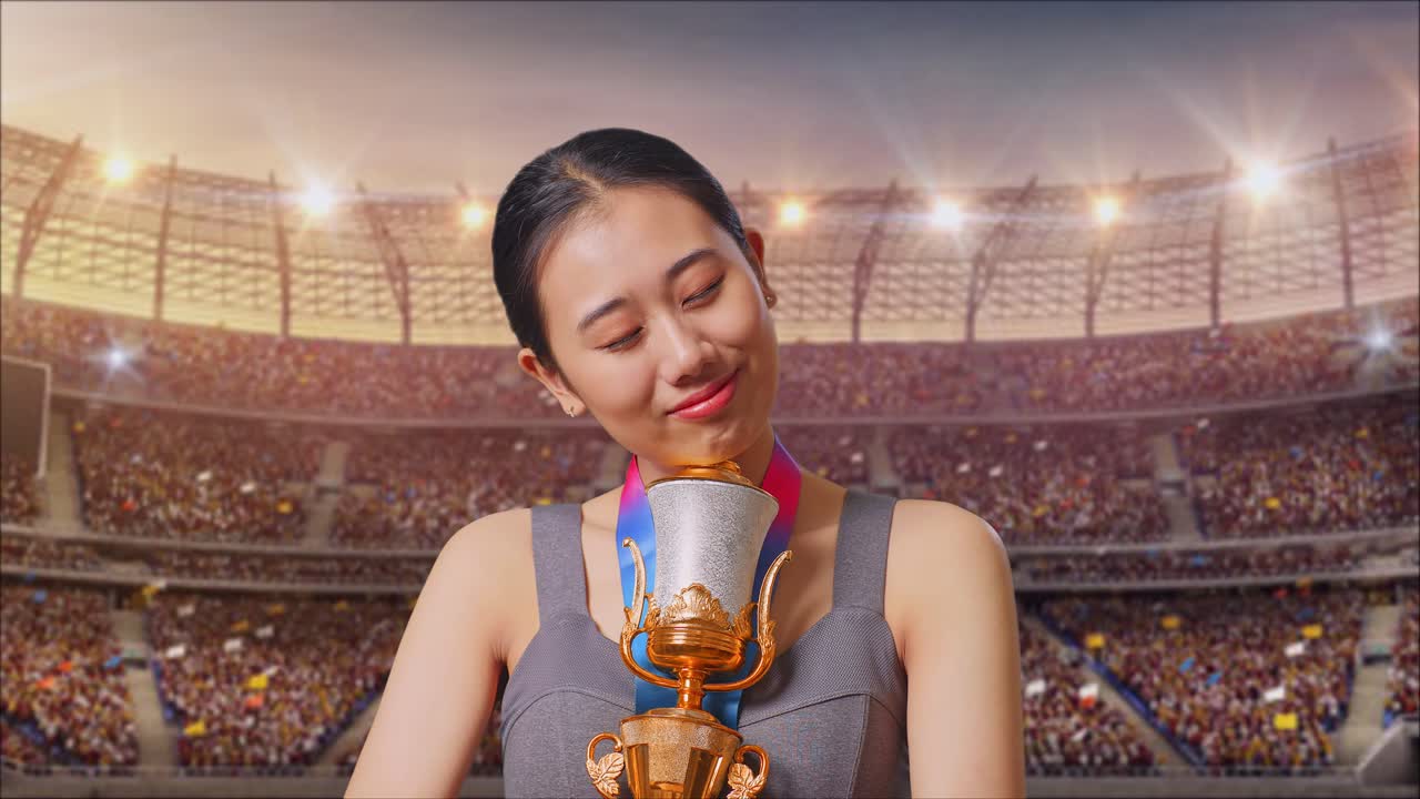 Woman holding a trophy in a stadium