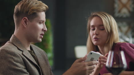 couple looking at phone in a restaurant