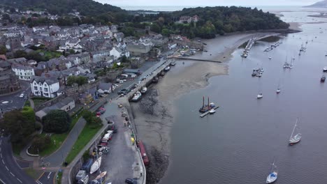 Aerial-view-Conwy-harbour-coastline-pan-left-across-medieval-castle-walled-market-town