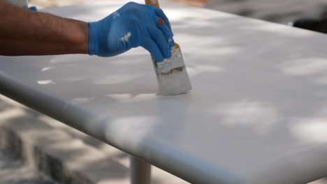 painting a table outdoors