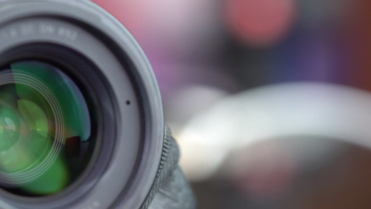 Close-up of a camera lens showing reflection and focus, creative imagery
