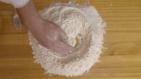 Chef-preparing-the-dough-form-for-adding-the-egg-yolk