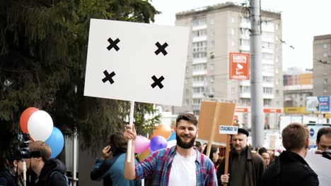 european people at demonstration. man with a banner screaming into a mouthpiece.