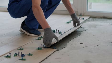 installing ceramic floor tiles - measuring and cutting the pieces. construction, renovation, repair apartment. cuts tile. tile cutting