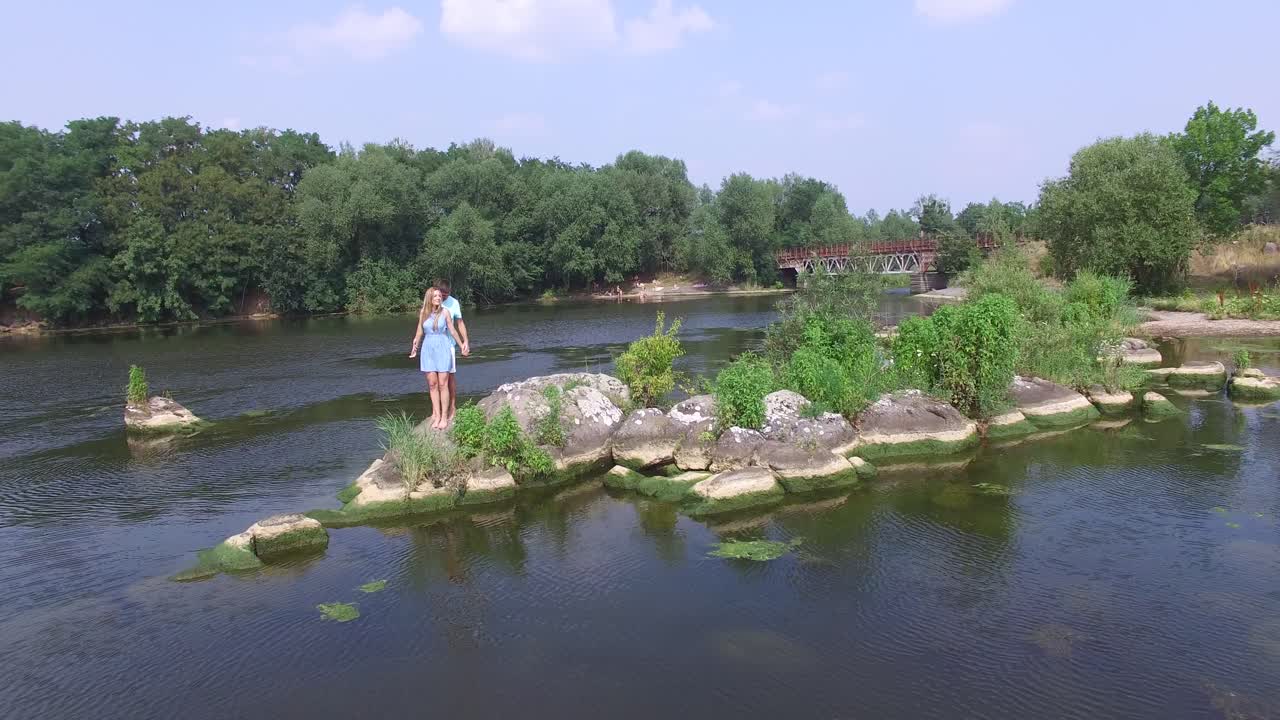 Couple Love Romance. Aerial shot of a couple love romance. Young couple in love play on the rivers beach