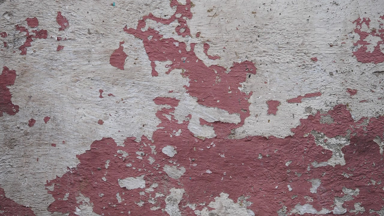 Abstract Texture of Peeling Red Paint on an Aged Wall
