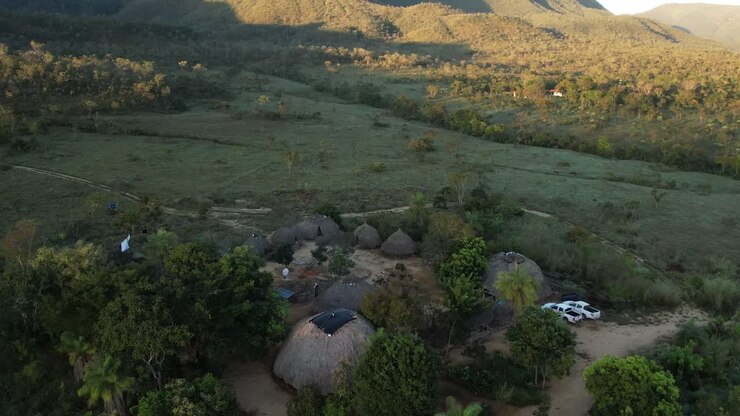 aerial view sunny village in Chapada dos Veadeiros "Aldeia Macaco" hollow-shaped bioconstruction houses cerrado landscape Goiás Brazil
