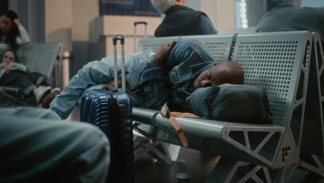 tired traveler sleeping in airport