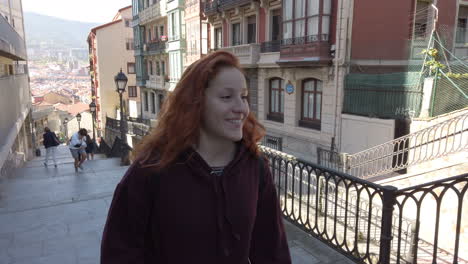 Woman on city street stairs