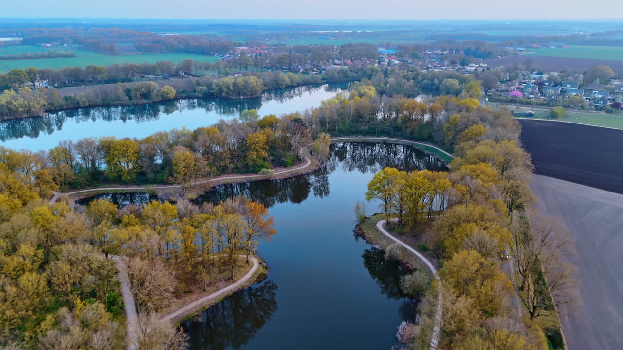 Autumn in the Netherlands. Aerial view of a serene autumn landscape in the Netherlands, showcasing winding waterways and colorful foliage