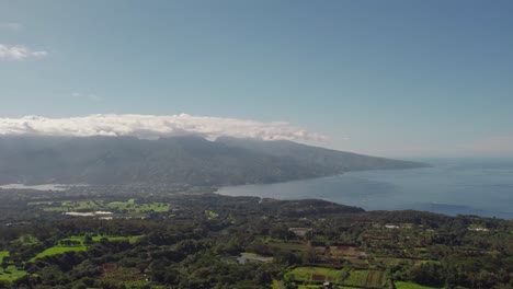 pan left aerial drone footage of tahiti island from mountain top to reveal stunning island landscape