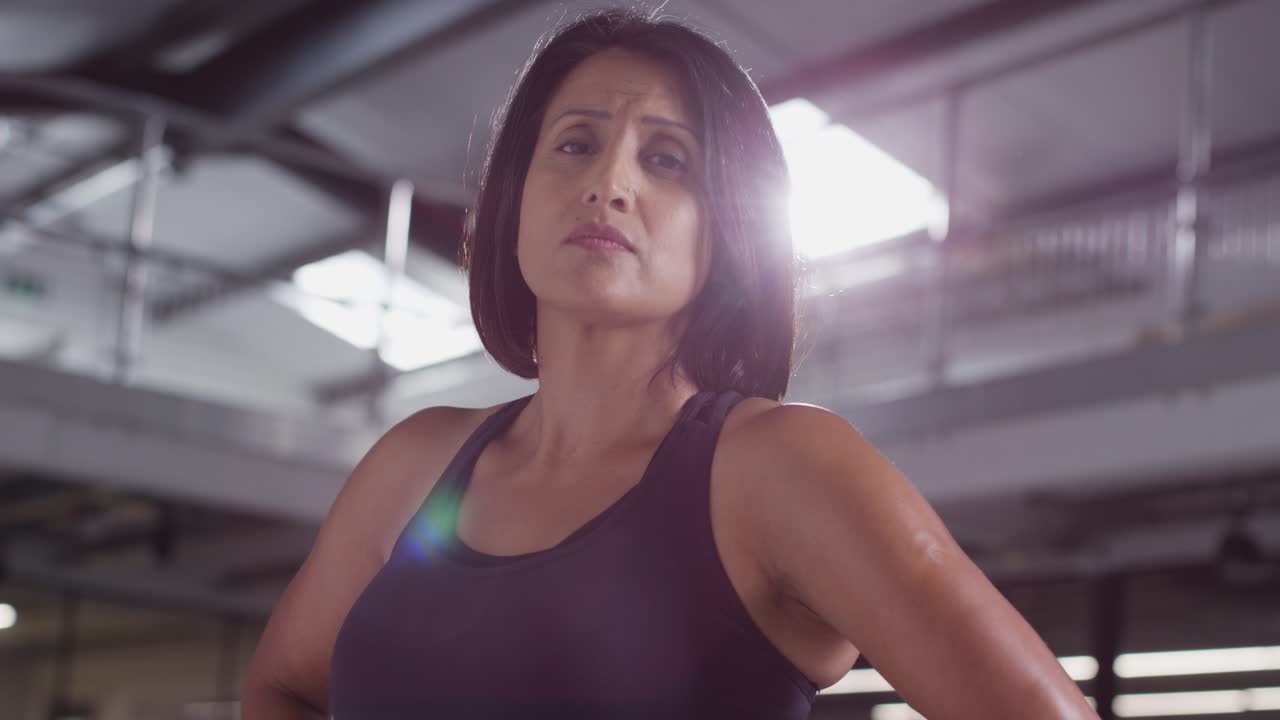 Portrait Of Mature Woman Wearing Fitness Clothing Standing In Gym Ready To Exercise