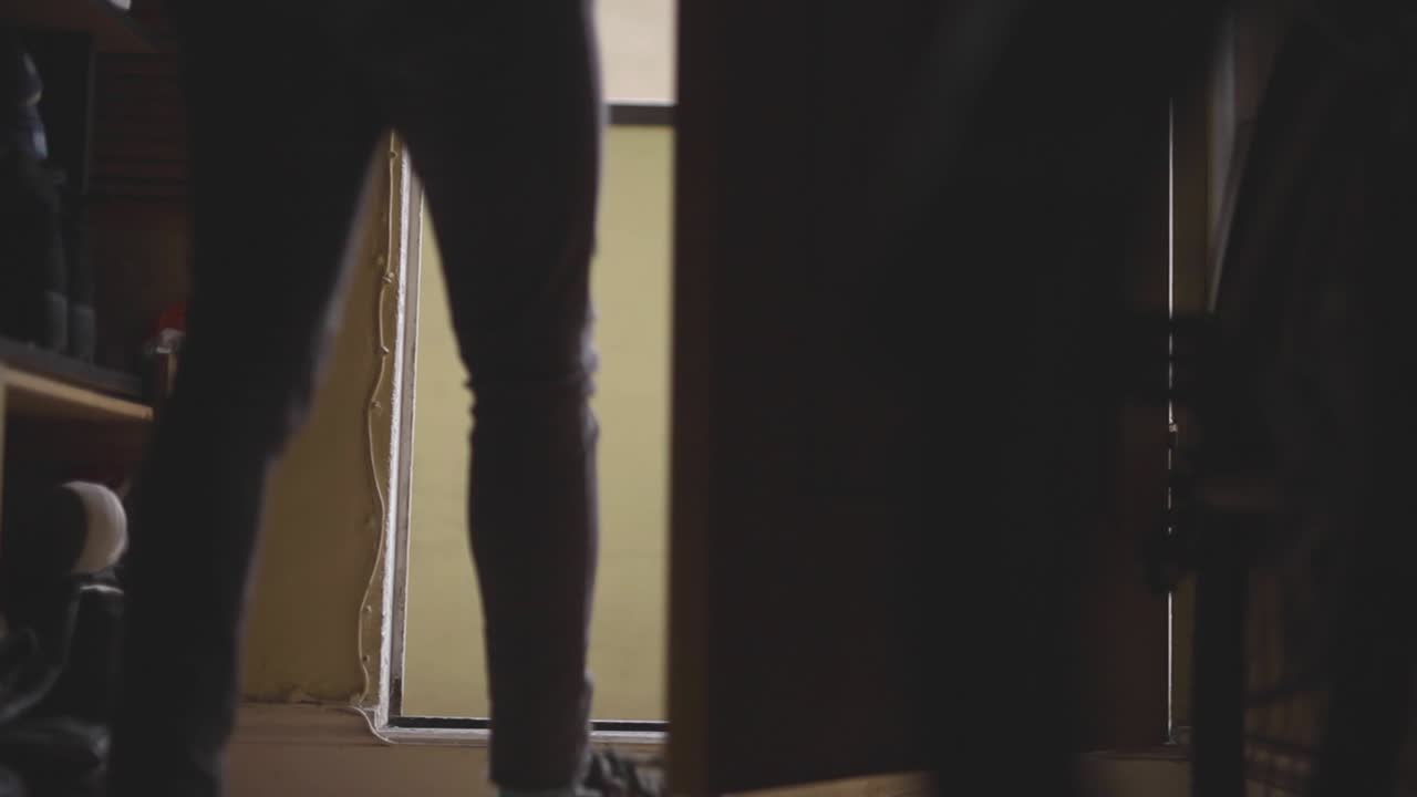 Man going out from his home, static shot, low angle