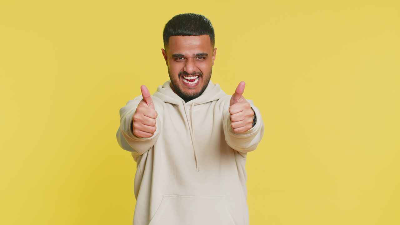 Indian man raises thumbs up agrees or gives positive reply recommends advertisement likes good idea