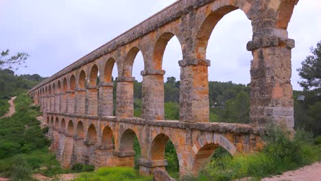 a beautiful roman aqueduct crosses a canyon in france 2