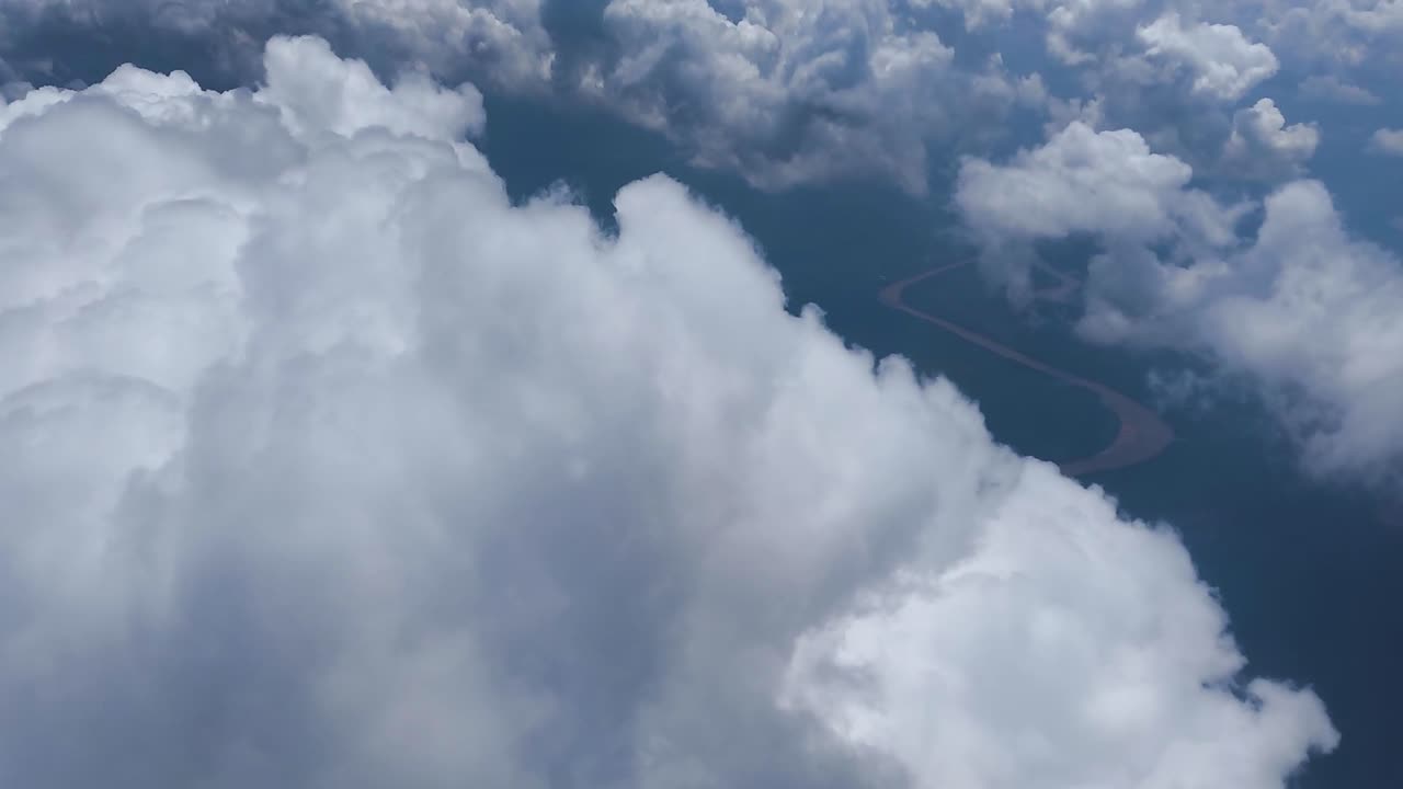 view of airplane cabin, close up of white clouds