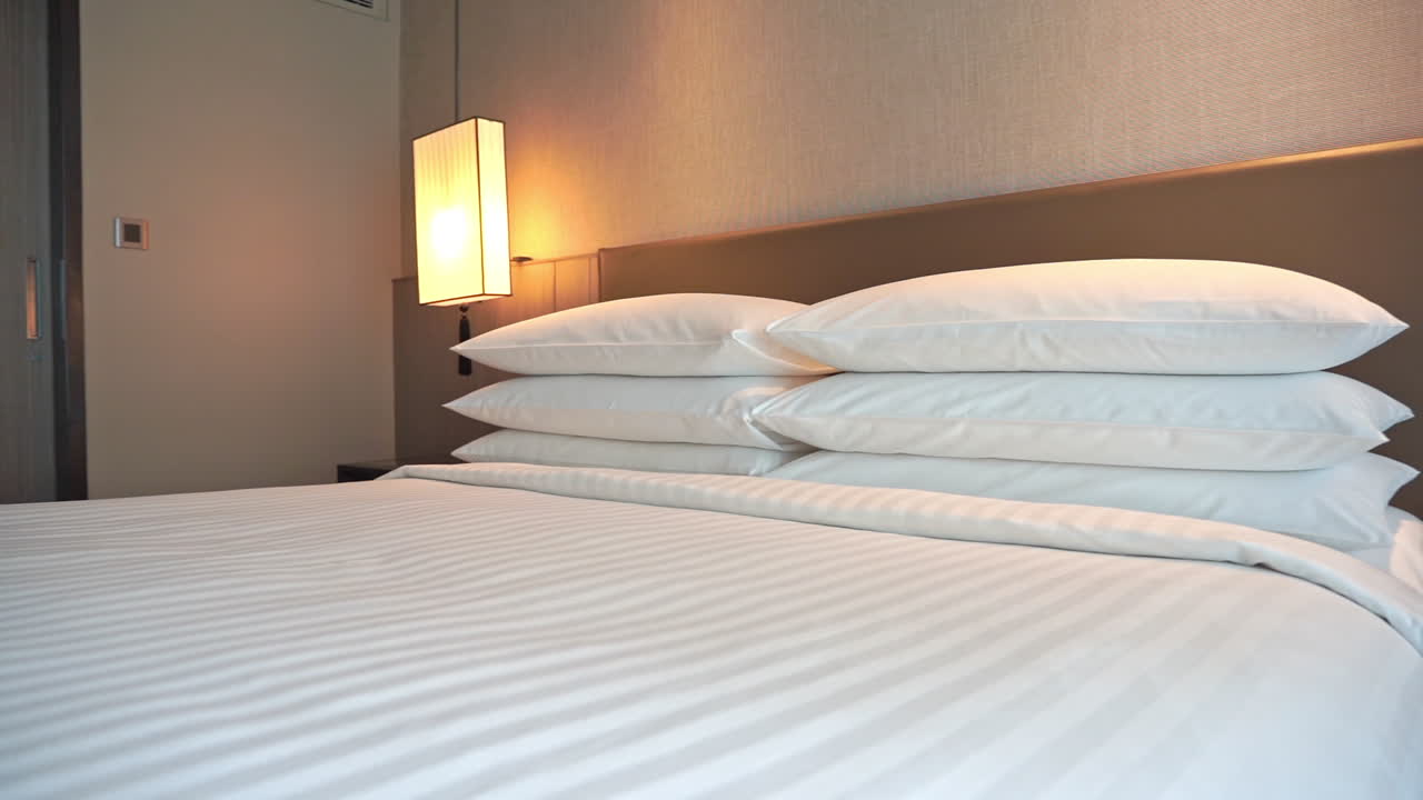 흰색 리넨으로 만든 침대 발치에서 머리판까지 팬