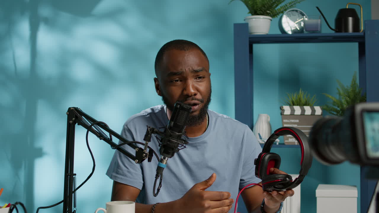 Blogger doing review for modern headphones on camera