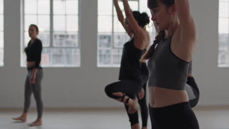 yoga-class-group-of-multiracial-women-practicing-tree-pose-enjoying-healthy-lifestyle-exercising-in-fitness-studio-instructor-teaching-group-meditation-at-sunrise