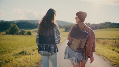 young happy friends walking on footpath in forest