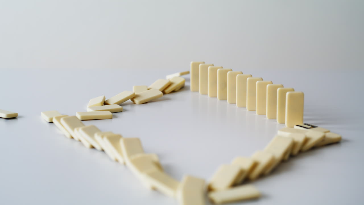 Man hand push domino on white surface closeup. Male finger touching rectangles