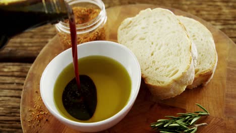 Bread,-rosemary-and-soy-sauce-being-poured-in-olive-oil