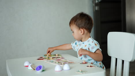 year and half toddler playing with puzzles. lovely kid studying through a game.