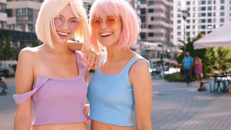 two women laughing outdoors in city