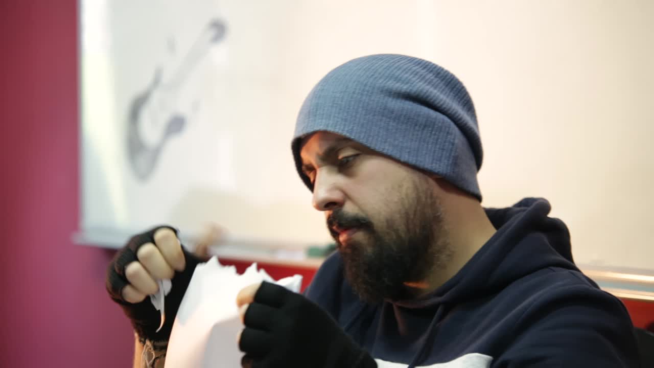 Office frustrated worker in a stylish outfit, tears papers reflecting high pressure of short deadline on finishing the project