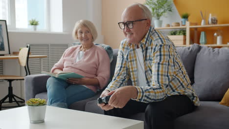 senior couple enjoying video games at home
