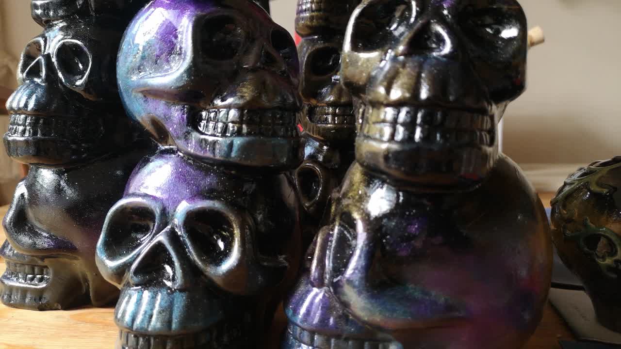 Colourful painted ceramic spooky death skull totem art crafts pottery ornament push in slow