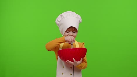 Child-girl-kid-dressed-as-cook-baker-chef-mix-dough-in-bowl,-prepare-cake-on-chroma-key-background