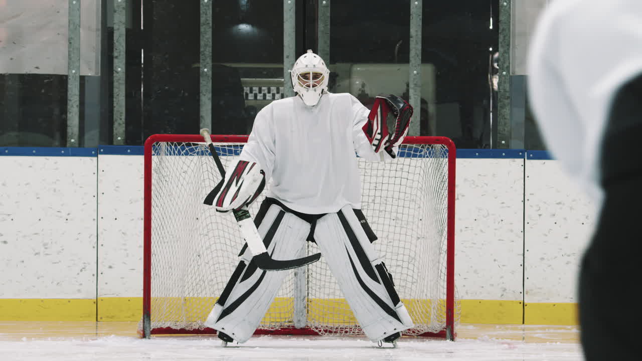Hockey Goaltender Catching Pucks
