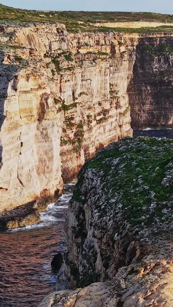 Cliffs and rocks along the coastline of Malta during the early evening