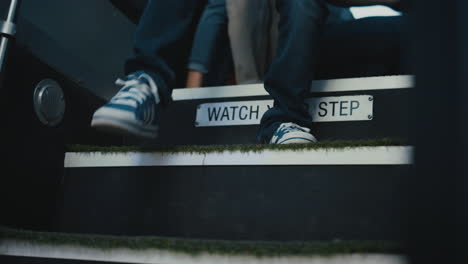 students legs leaving school bus closeup. children get down vehicle stairs.