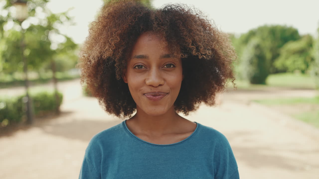 Portrait of a Smiling Black Woman in a Park