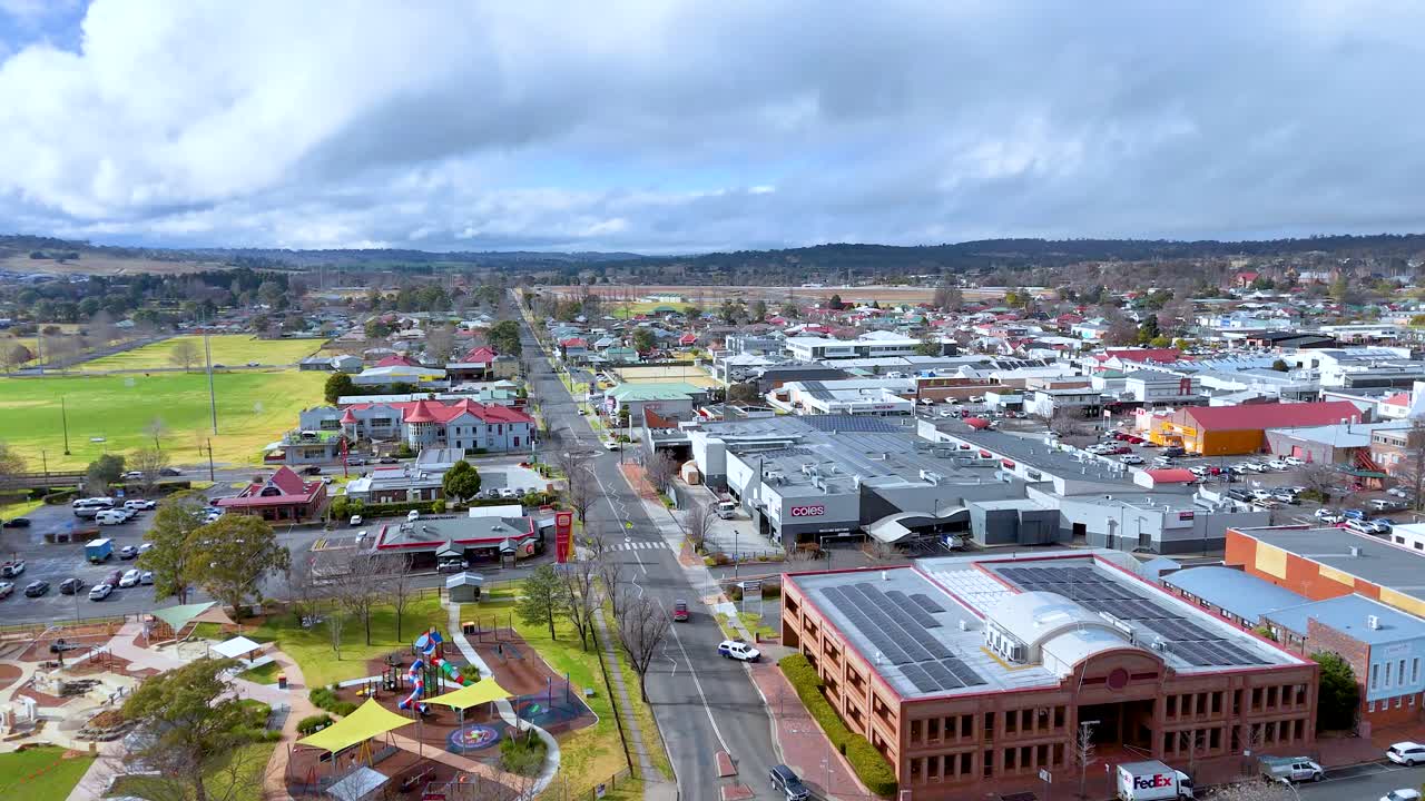 Drone footage of suburban streets, parks, and buildings