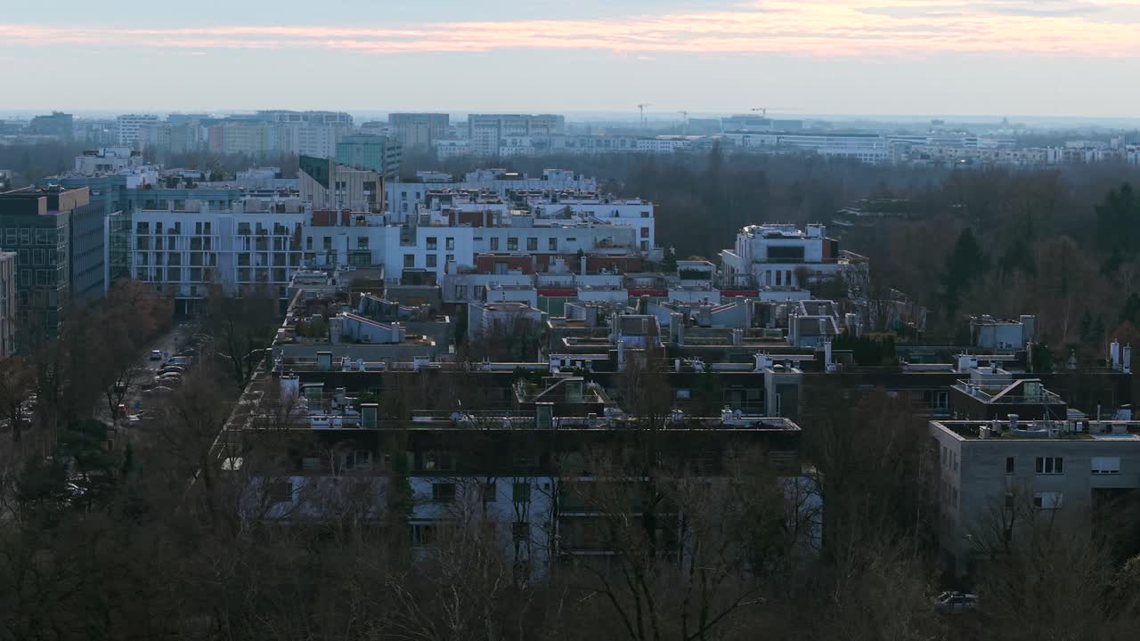 Drone flying above Warsaw Mokotow district real estate buildings and neighborhood in evening
