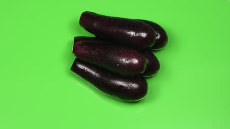 eggplant on green background. side view. loop motion. rotation 360.