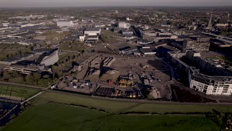 aerial approach of construction site at riverbank of river ijssel